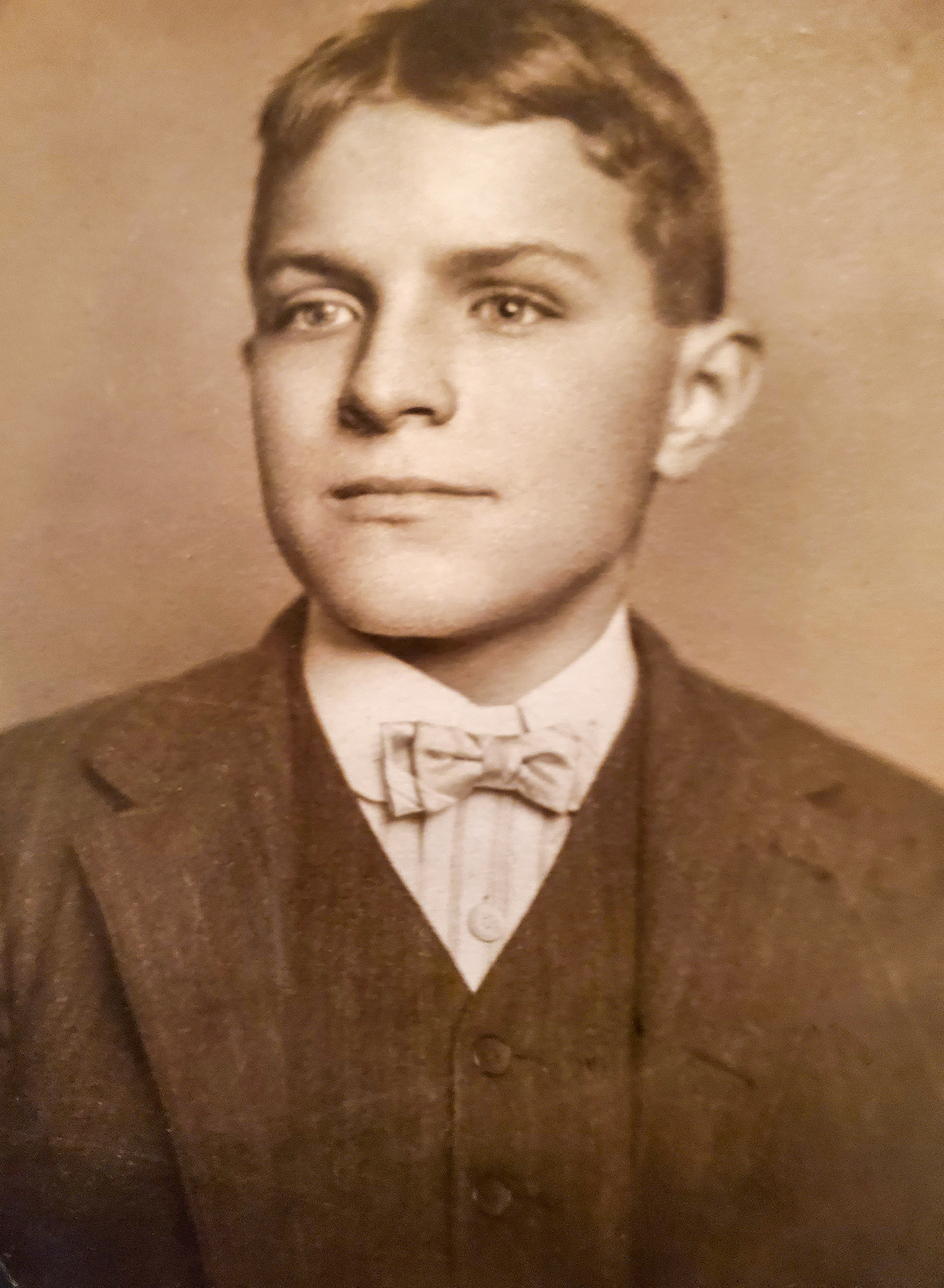 Portrait of young man wearing a suit and bowtie. 