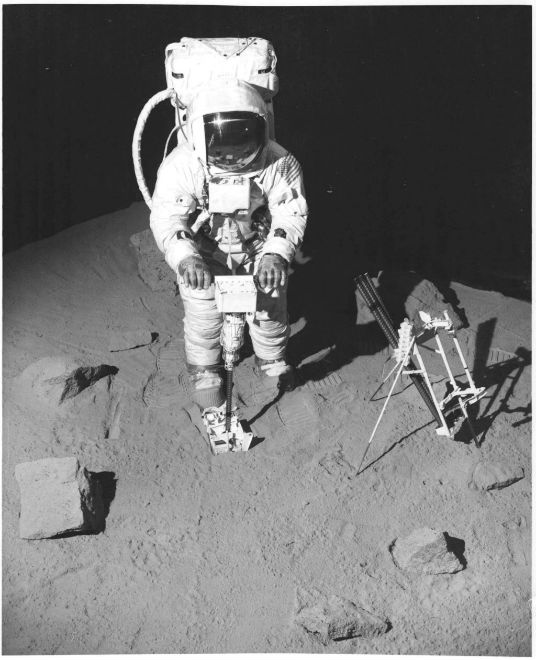 Image: The Black and Decker cordless Lunar Drill operated by an astronaut on a simulated surface of moon