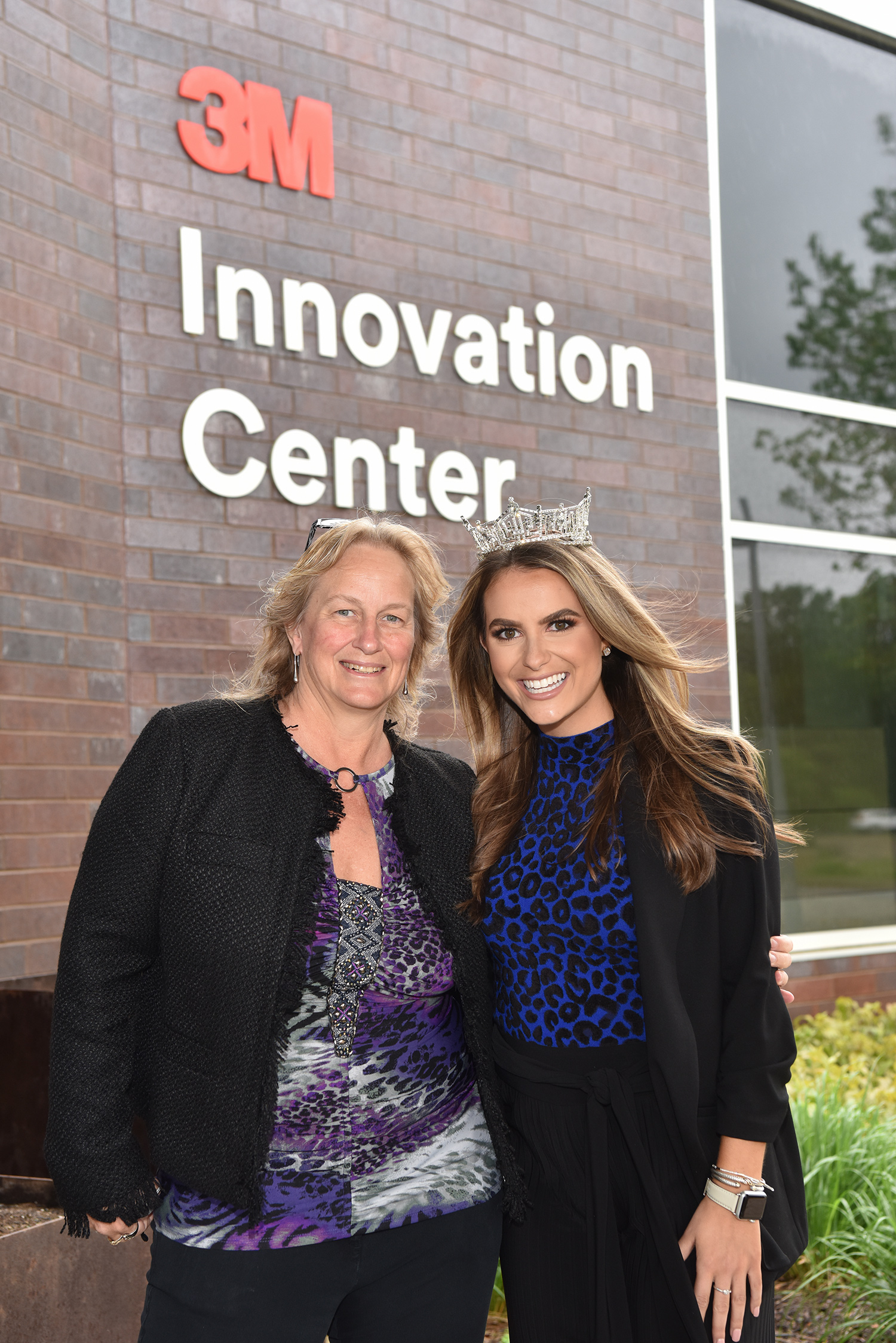 Audrey Sherman poses outside at 3M with Miss America Camille Schrier.