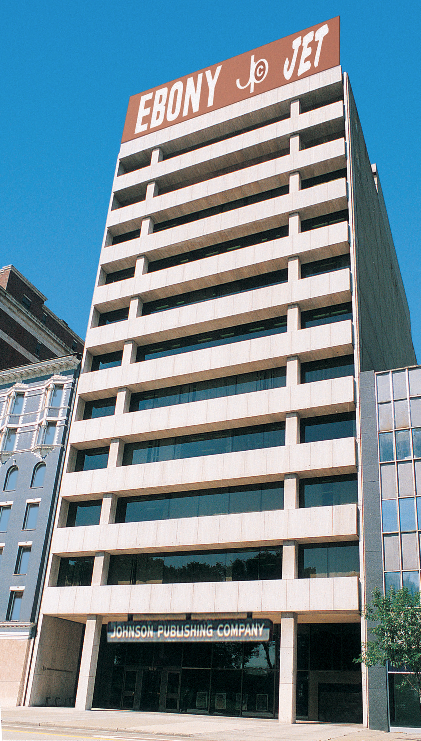 A ground level view of a multistory office building with the words Ebony and Jet displayed at the top.