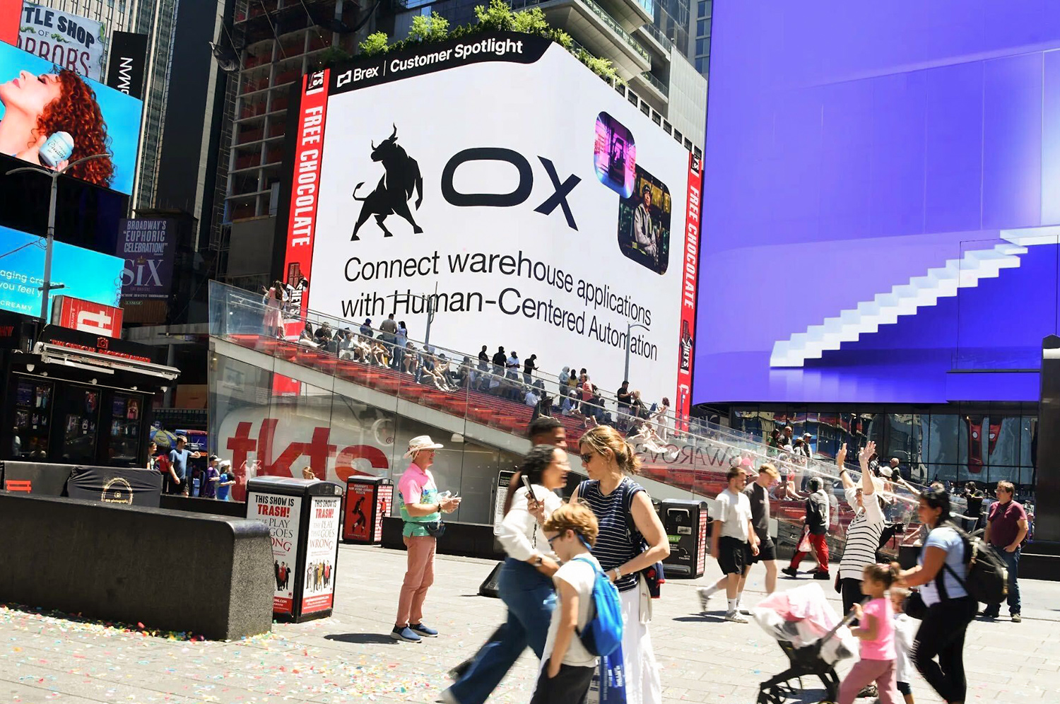 Billboard advertisement featuring an image of an ox with the word “ox” featured in crowded Times Square.