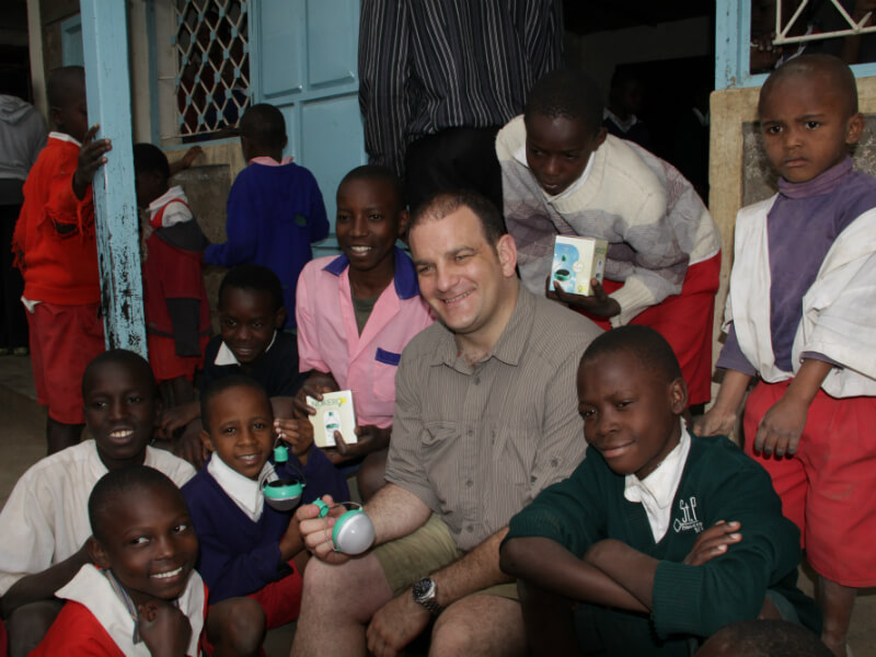 Image: Steve Katsaros and children holding Nokero solar light