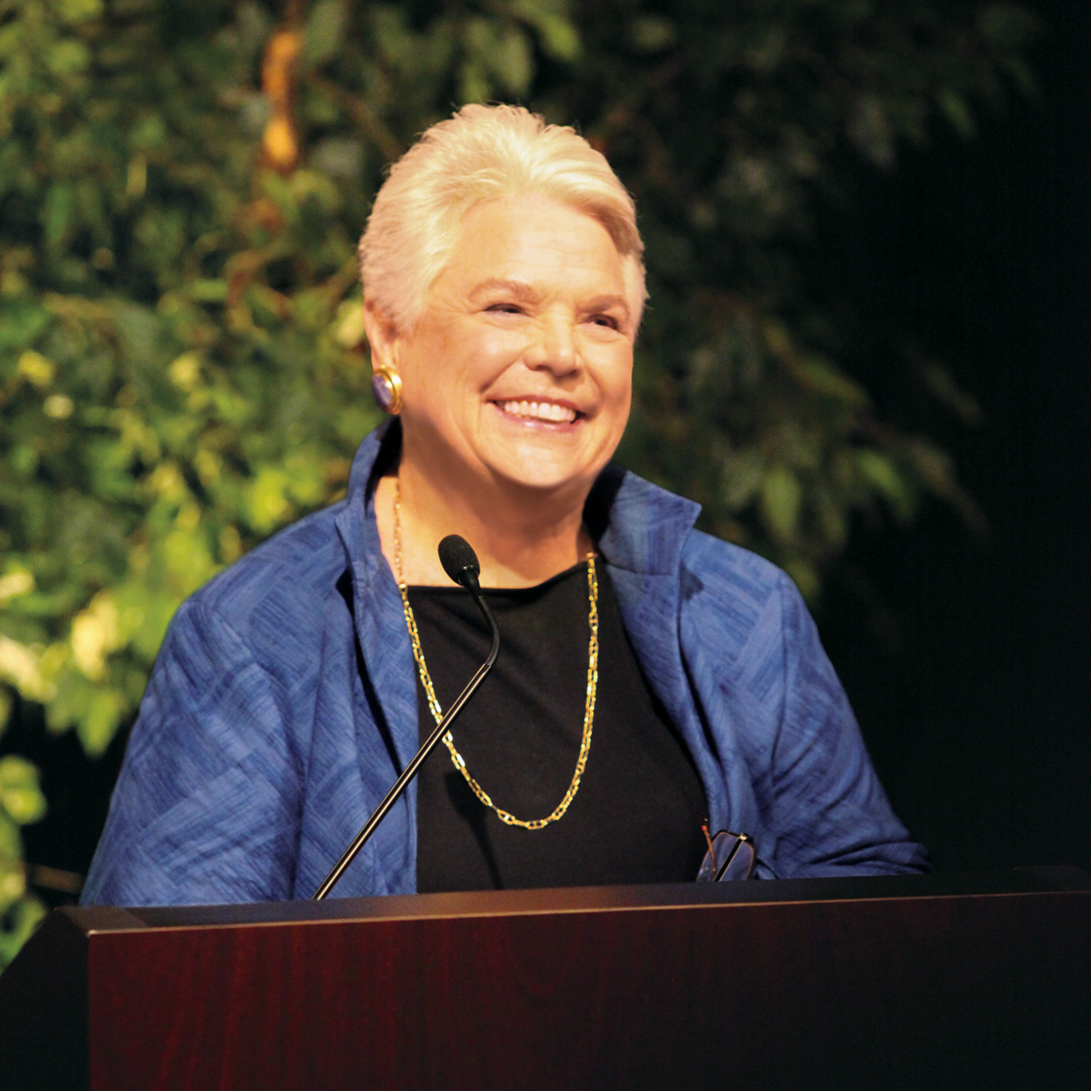 Pleasant T. Rowland smiles from behind a podium at an event celebrating the 25th anniversary of American Girl.