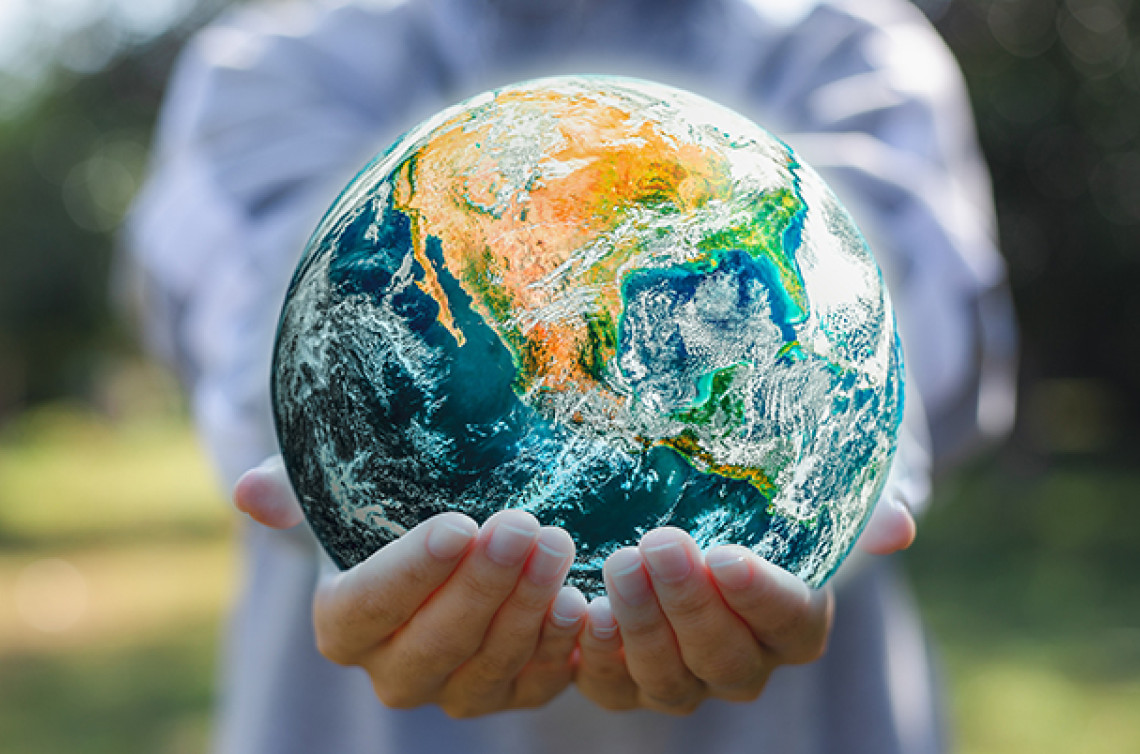 Close up of a person's holding an earth globe