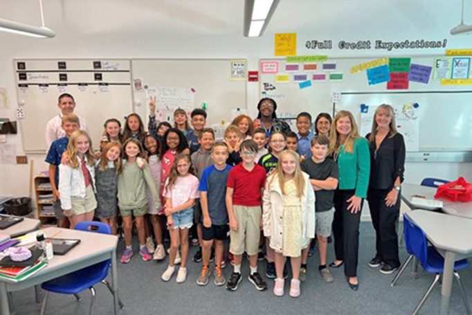 Director Vidal poses with 5th graders on the military base in Rota, Spain
