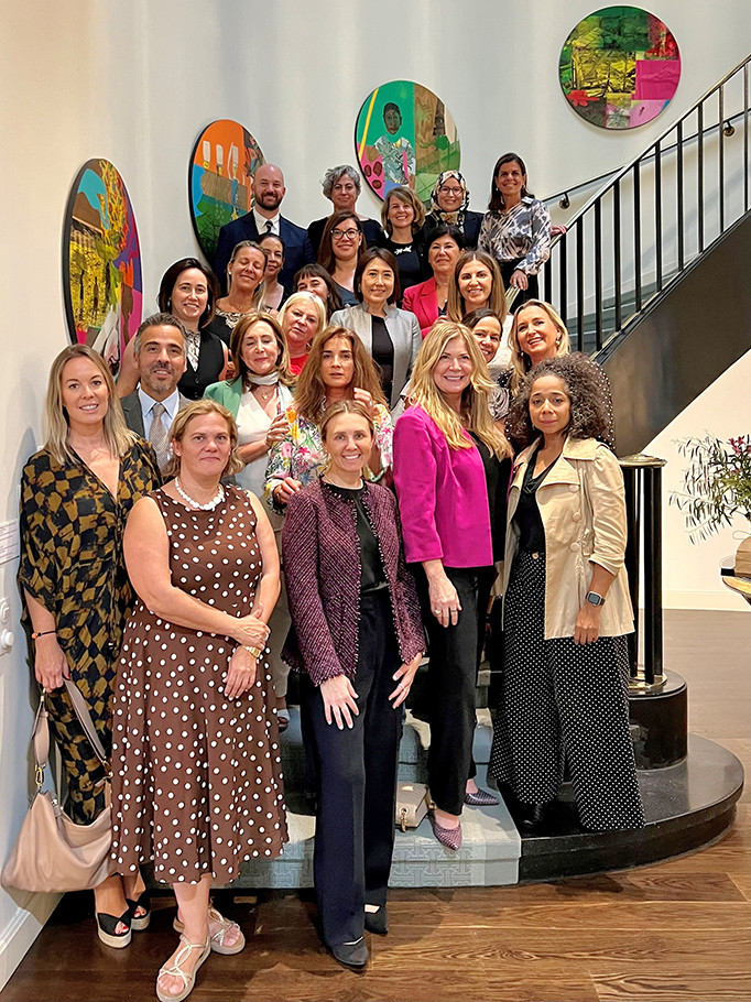 Director Vidal poses with women entrepreneurs on a staircase at Ambassador Julissa Reynosoa's residence in Madrid, Spain