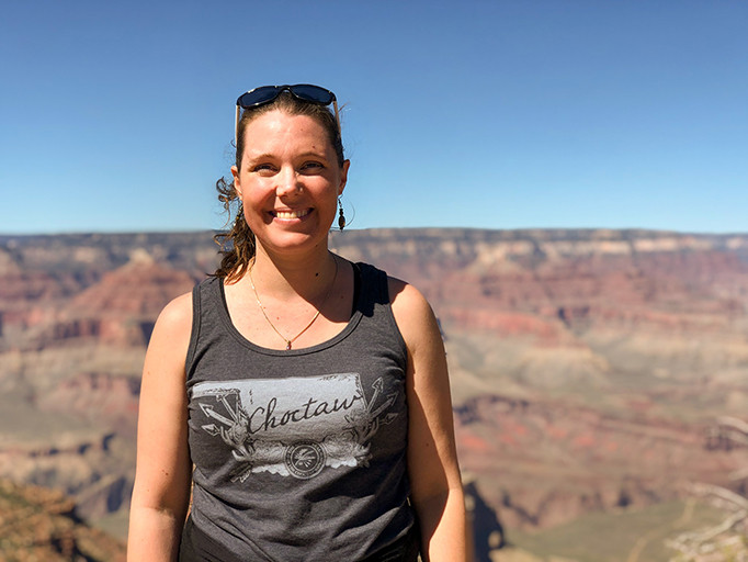 Tara Astigarraga smiles against a mountainanous backdrop