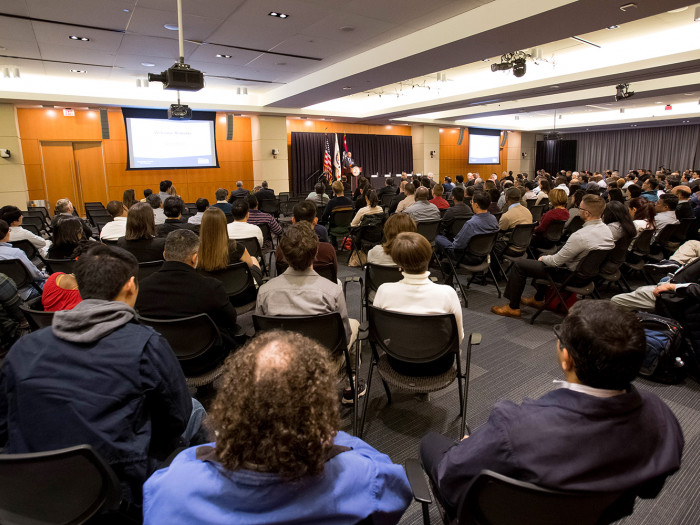 External stakeholders listen to remarks.