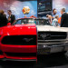 NIHF Museum exhibit featuring two halves of a Ford Mustang, a white half from 1965 and a red half fr