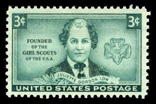 United States postage stamp showing the trefoil badge and Juliette Gordon Low in a Girl Scout uniform.