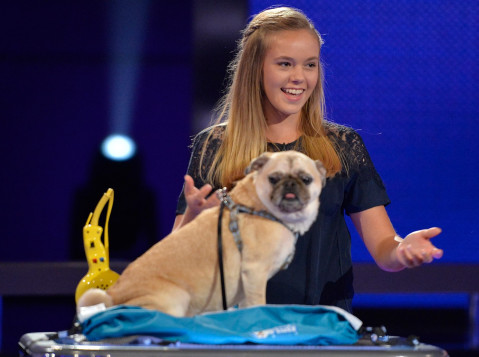 Marissa Streng holds her hands out toward her dog Mojo.