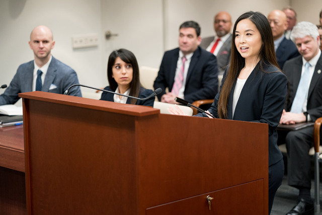 Woman at podium in PTAB hearing room