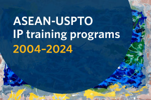 ASEAN-USPTO IP training programs, 2004-2024 text inside a navy blue circle. The background is an abstract painting in blue, yellow, green, and gray colors.