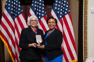 Paula T. Hammond and White House Office of Science and Technology Policy Director Arati Prabhakar smile and show a medal.