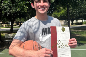 Travis Edwards with the patent certificate for his Follow Thru Fixer