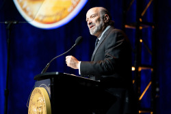 Secretary of Commerce Howard Lutnick speaks at a podium.