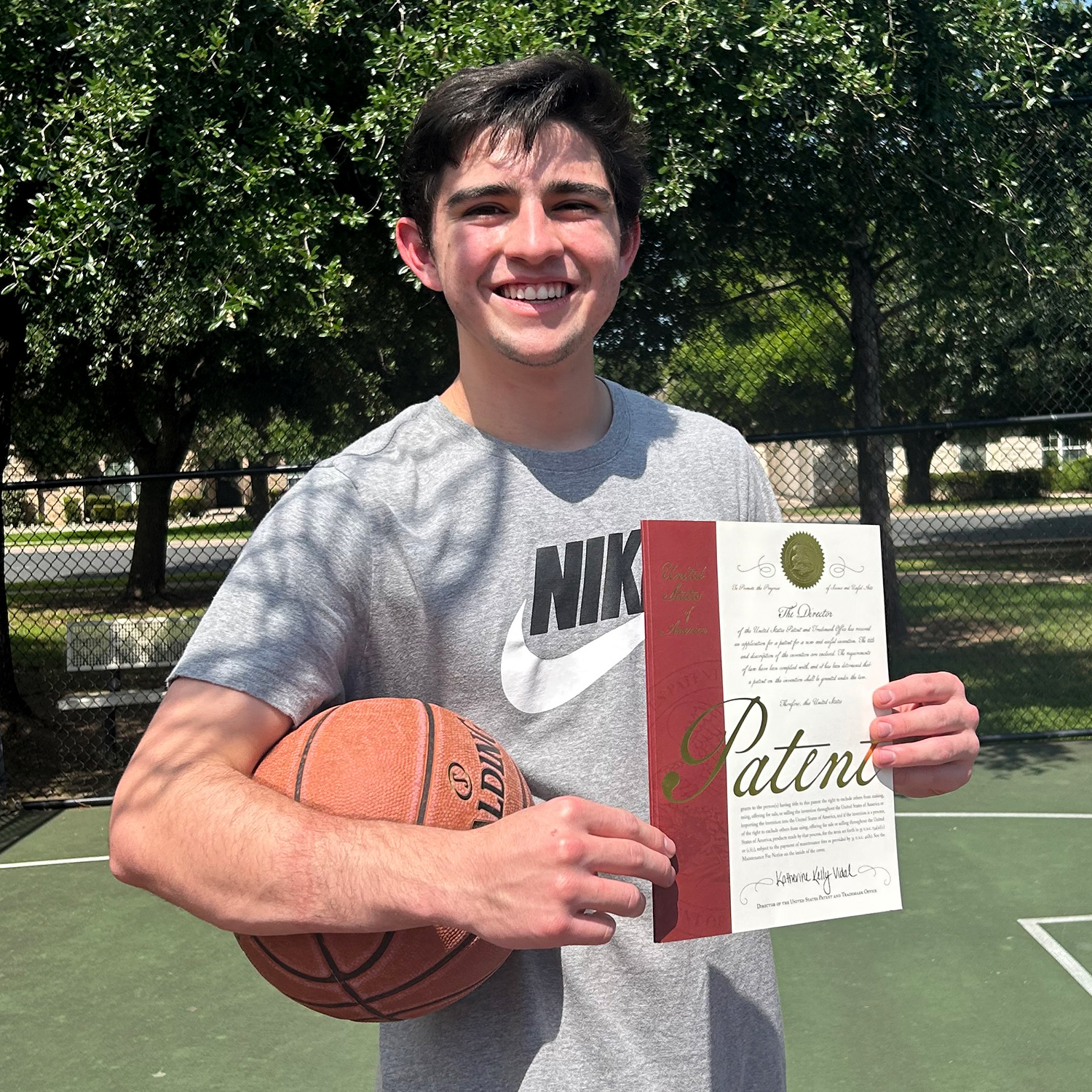 Travis Edwards with the patent certificate for his Follow Thru Fixer